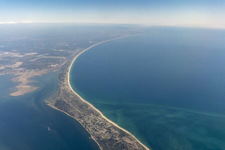 Aerial view of peninsula with beach between wetland Ria Formosa and Atlantic Ocean in Portugalの写真素材