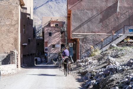 Imlil, Morocco - January 7, 2020: Berber man riding a horse in mountainous village in Atlasのeditorial素材