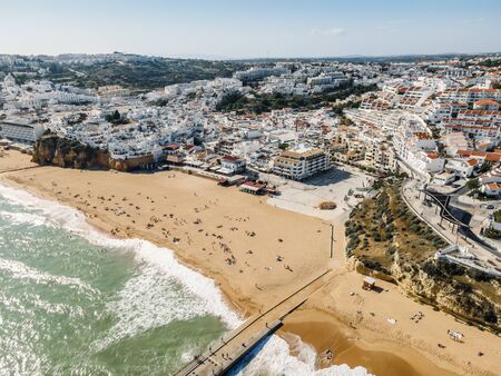 Aerial view of seaside Albufeira with wide beach and white architecture, Algarve, Portugal.の写真素材