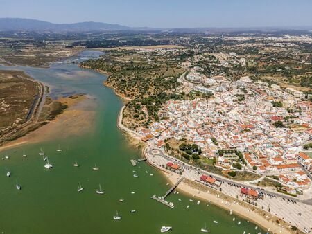 Aerial view of bay with yachts and city of Alvor, Algarve, Portugalの写真素材