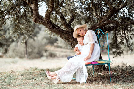 Pregnant woman spending time with her little son in the natureの写真素材