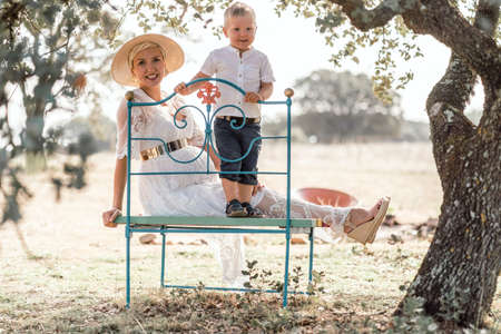 Pregnant woman spending time with her little son in the natureの写真素材