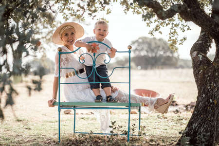 Pregnant woman spending time with her little son in the natureの写真素材