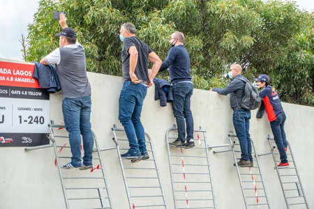 Portimao, Portugal - October 25, 2020: People watching Formula 1 championship through the fence....
