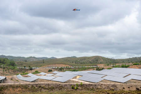 Helicopter with filming equipment over solar panels, Portugal