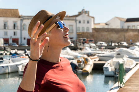 Woman enjoying sunny day in city center of Faro, Algarve, Portugalの写真素材
