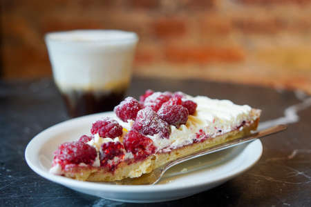 Delicious raspberry pie served with cappuccino coffeeの写真素材