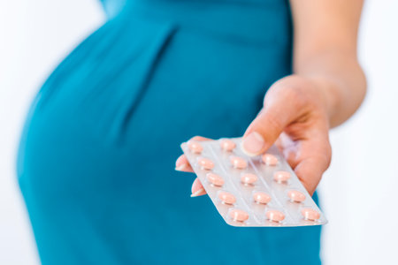 Pregnant woman holding nutritional supplement in her handの写真素材
