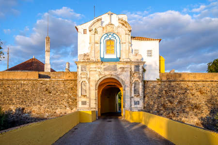 City walls with small church above gate leading to the historic center of Elvas, Alentejo, Portugalの写真素材