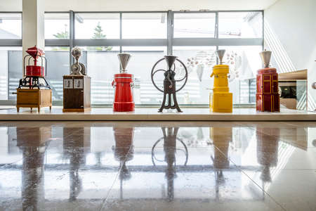 Beautiful vintage industrial coffee grinding machines in a rowの写真素材