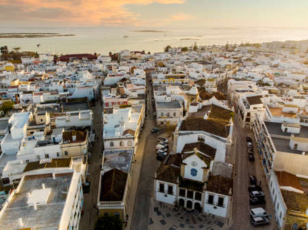 Aerial view of Olhao with a church in the foreground by sunset, Algarve, Portugal