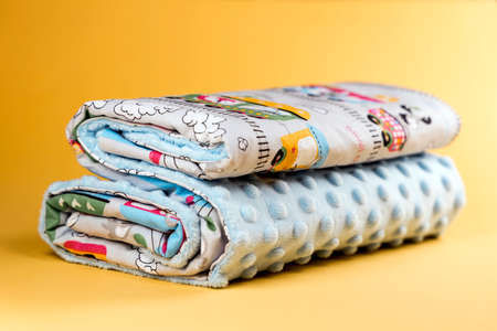 Sweet and cozy baby blanket with train pattern isolated on yellow backgroundの写真素材