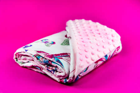 Sweet and cute pink baby blanket with butterfly pattern isolated on pink backgroundの写真素材
