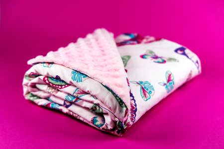 Sweet and cute pink baby blanket with butterfly pattern isolated on pink backgroundの写真素材