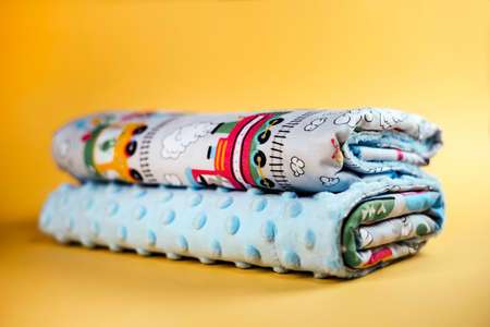 Sweet and cozy baby blanket with train pattern isolated on yellow backgroundの写真素材