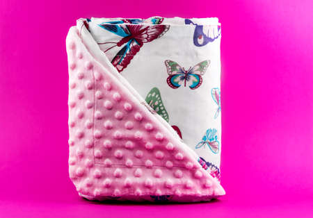 Sweet and cute pink baby blanket with butterfly pattern isolated on pink backgroundの写真素材