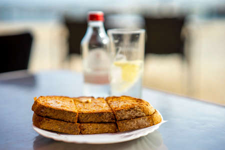 Tasty toast with salted butter on the outdoor table in Algarve, Portugalの写真素材