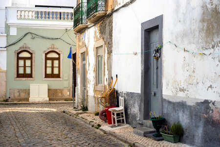 Narrow street of historic fishermen's town called Olhao, Algarve, Portugalの写真素材
