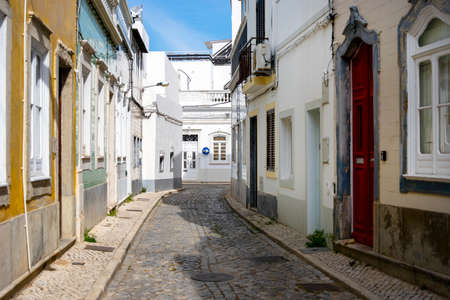 Narrow street of historic fishermen's town called Olhao, Algarve, Portugalの写真素材