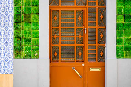 Metal doors to typical fisherman's house covered with tiles called azulejo, Olhao, Algarve, Portugalの写真素材