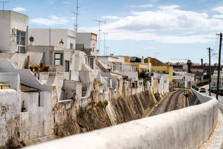 Cubist white washed houses by railway in Olhao, Algarve, Portugalの写真素材