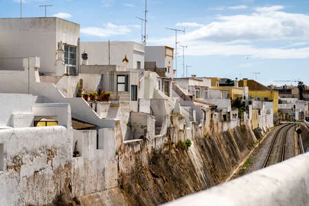 Cubist white washed houses by railway in Olhao, Algarve, Portugalの写真素材