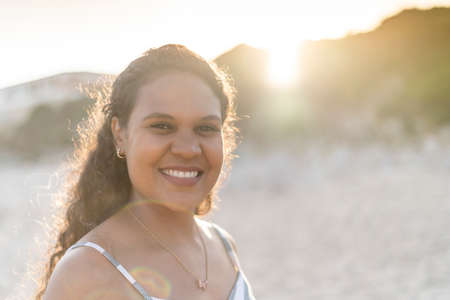 Portrait of a beautiful young woman on the beach by sunset in Algarve, Portugalの写真素材