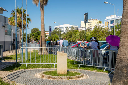 Olhao, Portugal - June 30, 2021: Many people in the line waiting for Covid-19 vaccine in front of...