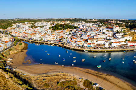 Aerial cityscape of white washed Ferragudo by Arade River, Algarve, Portugalのeditorial素材