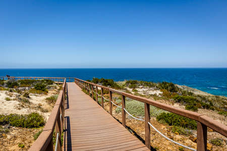 Wooden walkways by the Atlantic Ocean in Zambujeira Do Mar, Vicentina Coast Natural Park, Alentejo, Portugalの写真素材