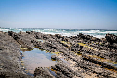 Rocks on the beach in Zambujeira Do Mar, Vicentina Coast Natural Park, Alentejo, Portugalの写真素材