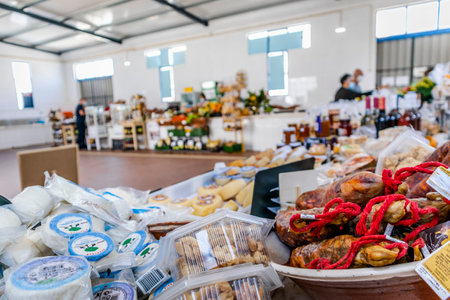 Zambujeira do Mar, Portugal - June 28, 2021: Traditional market with local products as cheeses, meats, vegetable and fruitsのeditorial素材