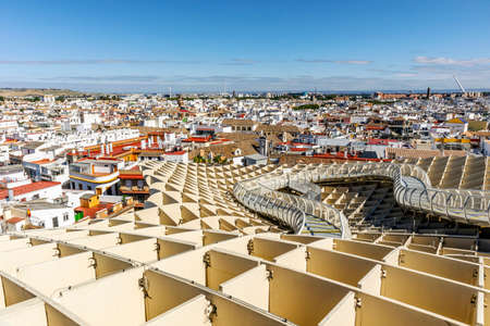 Seville skyline with wooden roof with walkways called Setas de Sevilla in the foreground, Andalusia, Spainの写真素材