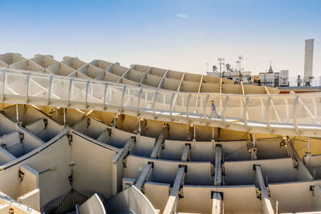 Small boy running on walkways of Setas de Sevilla - wooden construction with walkways on the roof in Seville, Andalusia, Spainの写真素材