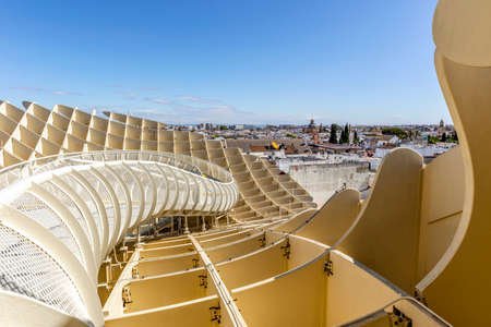 Seville skyline with wooden roof with walkways called Setas de Sevilla in the foreground, Andalusia, Spainの写真素材