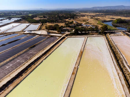 Amazing colors of sea salt ponds called salines shortly before salt harvest in Portugalの写真素材