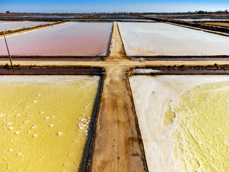 Amazing colors of sea salt ponds called salines shortly before salt harvest in Portugalの写真素材