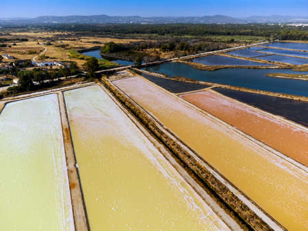 Amazing colors of sea salt ponds called salines shortly before salt harvest in Portugalの写真素材
