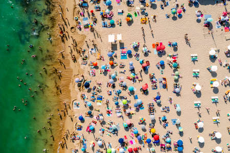 Drone shot of many people enjoying the beach and the ocean - vacation pattern. Rocha Beach in Portimao, Portugalの写真素材
