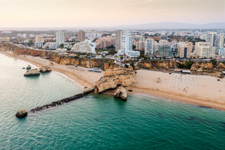 Aerial view of the cliffy coast in Portimao by sunset, Algarve, Portugalの写真素材