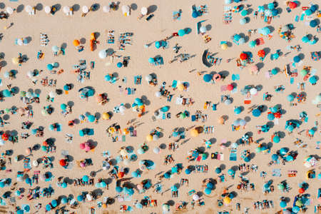 Drone shot of many people enjoying the beach and the ocean - vacation pattern. Rocha Beach in Portimao, Portugalの写真素材