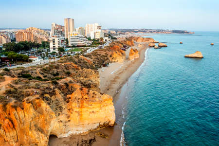 Aerial view of the cliffy coast in Portimao by sunset, Algarve, Portugalの写真素材