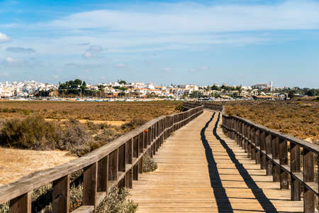 Wooden boardwalks by the coast of Alvor, Algarve, south of Portugalの写真素材