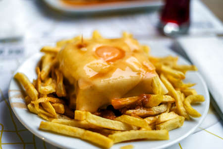 Delicious traditional francesinha served with french fries, Porto, Portugalの写真素材
