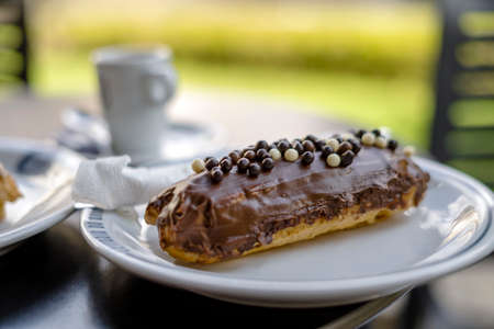 Tasty eclair pastry filled and covered with chocolate, Portugal