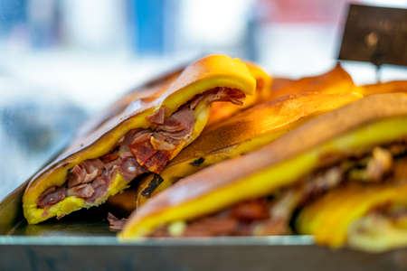 Delicious bread filled with chorizo in the baker's display, Porto, Portugalの写真素材
