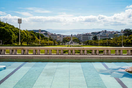 A fountain in Eduardo VII garden with a statue of Marquis of Pombal at the end, Lisbon, Portugalの写真素材