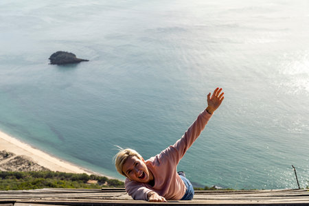 Woman falling from the high into the ocean, Viewpoint of Portinho da Arrabida, Portugalの写真素材