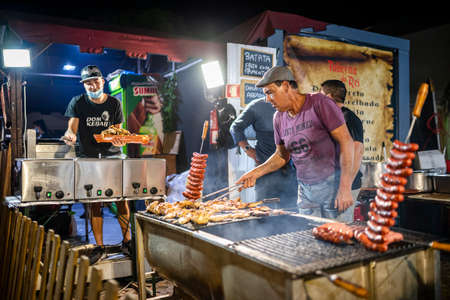Faro, Portugal - October 22, 2021: Delicious sausages and chicken grilled on charcoal during Santa Iria Fair in Algarveのeditorial素材