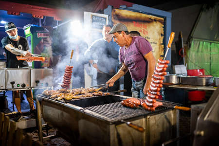Faro, Portugal - October 22, 2021: Delicious sausages and chicken grilled on charcoal during Santa Iria Fair in Algarveのeditorial素材